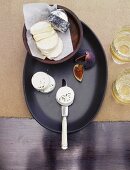 A cheese platter with goat's cheese, figs and white wine