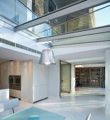 Open living room in a modern extension with glass roof and steel construction