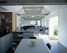 Open living room with dining room in the kitchen area in a converted barn