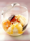 Apricots ice cream with baked apricots, apricots sauce and slivered almonds