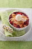Plum and pear crumble served with vanilla ice cream
