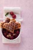 Heart-shaped waffles made from spelt flour with cherry compote