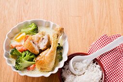 Chicken leg braised in coconut milk served with vegetables and rice