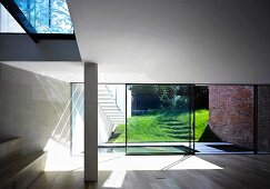 Leerer Wohnraum mit raumhohen Terrassenfenstern in zeitgenössischer Architektur