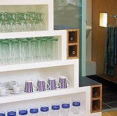 Glasses and mugs on a white pyramid shelf