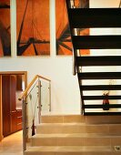 A stairway with stone step and the underside of a flight of stairs in an anteroom