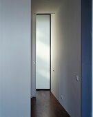 A minimalistic, white-painted hallway with parquet flooring