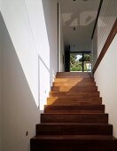 A play of light and shadow on a wall and on a flight of stairs