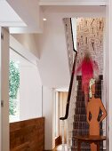 Renovated house with traditional staircase and modern art installation