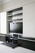 A modern living room cupboard with a flat screen television and a stereo cupboard