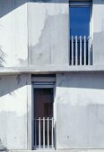 Concrete facade with French windows and railings