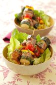 Pork and vegetable kebabs on lettuce