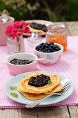 Pancakes with blueberry jam, blueberries and marmalade