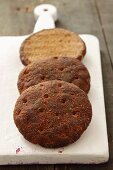 Three mini loaves of bread on a chopping board