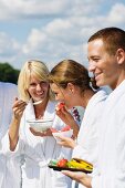 People in bath robes eating a healthy breakfast