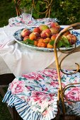 China dish of fresh fruit on garden table outdoors