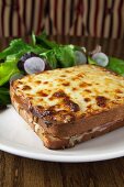 Croque Monsieur with Cheese on the Top on a White Plate