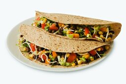 Two Vegetarian Tacos on Multi-Grain Tortillas; White Background