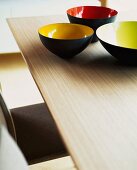 Set of coloured bowls on wooden table