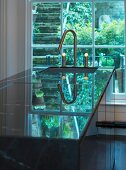 An island counter in a kitchen with a sink