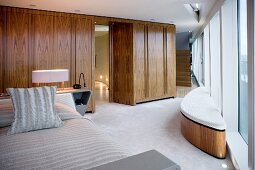 Bedroom with fitted wardrobes and expansive glass walls