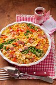 A pasta bake with sausages, peas and sweetcorn
