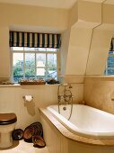 Rustic bathroom with ceramic bowls next to bathtub