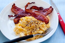 Scrambled Eggs and Bacon on a White Plate