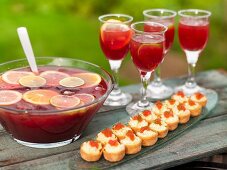 Sangria and potato and cheese pastries with caviar