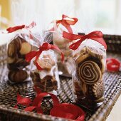 Various Christmas biscuits in bags on tray