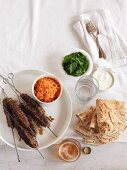 Minced lamb kebabs with carrots, mint, yogurt and unleavened bread