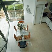 Dining area with glass wall leading to terrace