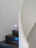 Wooden spiral staircase with white balustrade & integrated lights