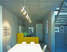 A meeting room with a white table and chairs