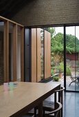 Living space with dining area & view of terrace, garden & extension