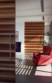 Sliding doors made of various types of wood in open-plan interior