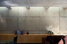 Sideboard aus Holz vor Betonwand im zeitgenössischen Wohnhaus