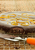 A chocolate cake being glazed