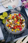 Summer salad with tomatoes and exotic fruits