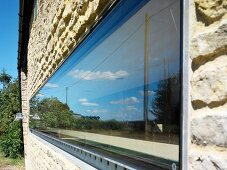 Horizontal, narrow window in stone facade