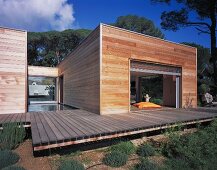 Modern, flat-roofed, wooden house with terrace