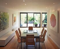 Dining room with glass table and wicker chairs