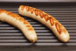 Two sausages on a grill