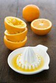 Squeezed and unsqueezed orange halves and citrus squeezer