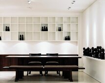 Elegant, designer dining area with collection of black, African figures