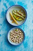 White beans and pods in two dishes