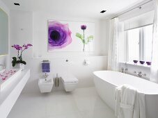 White designer bathroom with modern picture with floral motif on wall