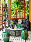 Couch, coffee table and ceramic stools on terrace