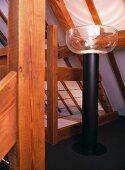 Chunky standard lamp beneath sloping attic ceiling