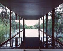 Contemporary building with glass facade and view of garden